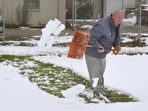 Kentucky Wesleyan College's woman's soccer coach Jamie Duvall shovels snow to clear an open section of field at Panther Field in Owensboro, Ky., Monday, March 12, 2018. Duvall was clearing snow from an area of the field before it melted and cause the field to become too muddy to practice on as they try to get ready for a game this Saturday.