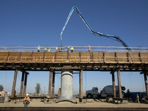 FILE - In this Dec. 6, 2017, file, workers pour concrete on to one of the elevated sections of the high-speed rail that will cross over the San Joaquin River, near Fresno, Calif. California Gov. Jerry Brown on Monday, March 12, 2018, invited President Donald Trump to visit the state's high-speed rail construction projects while he is in the state this week to examine prototypes of the wall he wants to build along the U.S.-Mexico border.