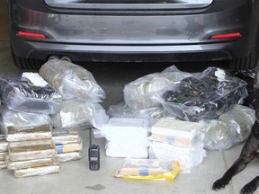 This Tuesday, March 13, 2018 photo released by the Yavapai County Sheriff's Office shows a dog "Vader," a north-central Arizona specially trained police dog who helped them find a load of cocaine and marijuana inside a BMW sedan driven by a 20-year-old Texas man they arrested during a traffic stop. The Yavapai County Sheriff's Office said Tuesday that it arrested Eduardo Pedro Martinez about 7 a.m. Monday following a stop in the town of Ash Fork, Ariz. Martinez was arrested for failure to comply with a police officer after initially refusing to leave the car.