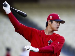 Los Angeles Angels starting pitcher Shohei Ohtani, of Japan, warms up before the team's preseason baseball game against the Los Angeles Dodgers, Tuesday, March 27, 2018, in Los Angeles.