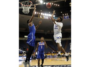 Georgia State guard Devin Mitchell, right, shoots against Texas-Arlington center Johnny Hamilton, left, in the first half of the the Sun Belt Conference NCAA college basketball championship game in New Orleans, Sunday, March 11, 2018.