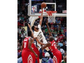 New Orleans Pelicans forward Anthony Davis (23) goes to the basket over Houston Rockets forward Luc Mbah a Moute (12) in the first half of an NBA basketball game in New Orleans, Saturday, March 17, 2018.