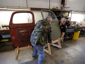 Joey Cullligan, right, and Bill Kingman restoration specialists for the National WWII Museum, move a door from a 1940's era fire truck, in their warehouse in New Orleans, Wednesday, March 7, 2018. The National World War II Museum is taking apart the recently acquired fire engine, made for the military home front in 1943, and expects to have it rolling and ready for display in two or three years.