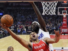 Houston Rockets guard Eric Gordon shoots as Los Angeles Clippers forward Montrezl Harrell defends during the first half of an NBA basketball game Wednesday, Feb. 28, 2018, in Los Angeles.