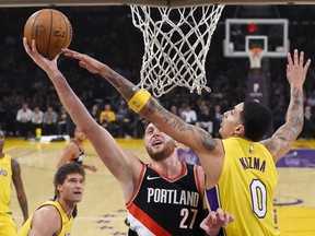 Portland Trail Blazers center Jusuf Nurkic (27) shoots as Los Angeles Lakers forward Kyle Kuzma defends during the first half of an NBA basketball game, Monday, March 5, 2018, in Los Angeles.