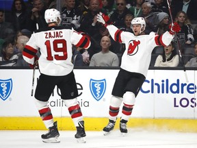 New Jersey Devils' Michael Grabner, of Austria, celebrates his goal with teammate Travis Zajac during the first period of an NHL hockey game against the Los Angeles Kings, Saturday, March 17, 2018, in Los Angeles.