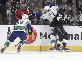 Vancouver Canucks center Bo Horvat (53) and defenseman Michael Del Zotto (4) collide with Los Angeles Kings center Alex Iafallo (19) in the first period of an NHL hockey game in Los Angeles, Monday, March 12, 2018.
