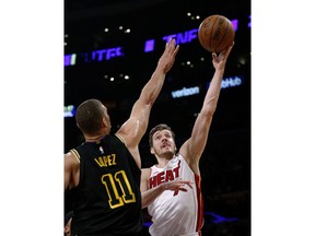 Miami Heat guard Goran Dragic, right, goes to the basket while defended by Los Angeles Lakers center Brook Lopez during the first half of an NBA basketball game Friday, March 16, 2018, in Los Angeles.