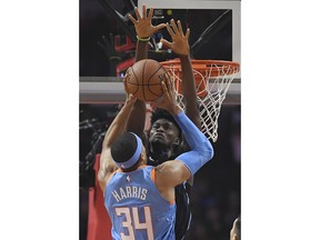 Los Angeles Clippers forward Tobias Harris, front, shoots as Orlando Magic forward Jonathan Isaac defends during the first half of an NBA basketball game Saturday, March 10, 2018, in Los Angeles.