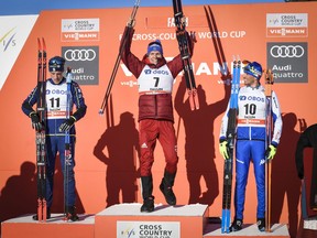 Winner Alexander Bolshunov of Russia, center, celebrates on the podium with second placed Calle Halfvarsson of Sweden, left, and third placed Francesco de Fabiani of Italy after the FIS World Cup Cross Country Men's 15.0 km Mass Start Classic event in Falun, Sweden, on Saturday March 17, 2018.