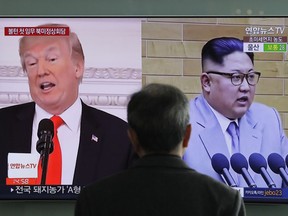 A man watches a TV screen showing file images of U.S. President Donald Trump, left, and North Korean leader Kim Jong Un, right, during a news program at the Seoul Railway Station in Seoul, South Korea, Tuesday, March 27, 2018.