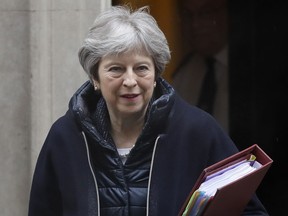 Britain's Prime Minister Theresa May leaves 10 Downing Street to attend the weekly session of Prime Minister Questions at Parliament in London, Wednesday, March 28, 2018.
