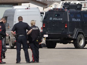 Calgary police and tactical team vehicle at the shooting scene of a police officer in Calgary, Alta. on Tuesday, March 27, 2018.