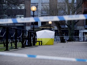 A police tent is framed by police tape covering the the spot where former Russian double agent Sergei Skripal and his daughter were found critically ill Sunday following exposure to an "unknown substance" in Salisbury, England, Wednesday, March 7, 2018. Britain's counterterrorism police took over an investigation Tuesday into the mysterious collapse of the former spy and his daughter, now fighting for their lives. The government pledged a "robust" response if suspicions of Russian state involvement are proven. Sergei Skripal and his daughter are in a critical condition after collapsing in the English city of Salisbury on Sunday.