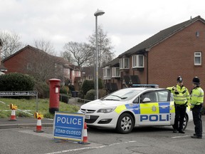 Police officers stand guard at the bottom of the road where former Russian double agent Sergei Skripal lives in Salisbury, England, Tuesday, March 13, 2018. The use of Russian-developed nerve agent Novichok to poison ex-spy Sergei Skripal and his daughter makes it "highly likely" that Russia was involved, British Prime Minister Theresa May said Monday. Novichok refers to a class of nerve agents developed in the Soviet Union near the end of the Cold War.