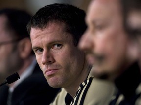 FILE - This is a Tuesday, Feb. 24, 2009 file photo of  Liverpool's Jamie Carragher as he listens to a question during a press conference ahead of a Champions League, Round of 16, first leg soccer match against Real Madrid at the Santiago Bernabeu Stadium in Madrid. The Sky television network Monday March 12, 2018 suspended soccer announcer Jamie Carragher after the former Liverpool player was filmed spitting in the direction of a 14-year-old girl through his car window. The incident happened Saturday after Carragher left Old Trafford. He had been there working for Sky Sports at Manchester United's game against Liverpool.
