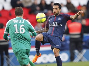 FILE - In this Wednesday, March 14, 2018 file photo, PSG's Dani Alves, right, vies for the ball with Angers' Ludovic Butelle during the French League One soccer match between Paris Saint-Germain and Angers at the Parc des Princes Stadium, in Paris, France. Alves took Paris Saint-Germain a step closer to the French title on Sunday, March 18, 2018 scoring his first league goal of the season with a late header as PSG won 2-1 at Nice.