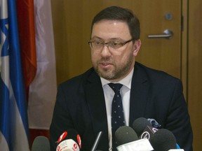 FILE _ in this file photo dated Thursday, March 1, 2018, Deputy Foreign Minister of Poland Bartosz Cichocki, speaks during a meeting at the Foreign Ministry in Jerusalem. Cichocki denied reports Tuesday March 6, 2018,  that the U.S. is punishing Poland over a controversial new Holocaust law, which imposes prison sentences for falsely and intentionally attributing the crimes of Nazi Germany to Poland.