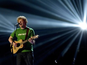 FILE - In this file photo dated Tuesday, Feb. 21, 2012, Ed Sheeran performs during the Brit Awards 2012 at the O2 Arena in London. Organizers said Tuesday March 6, 2018, that a concert by Sheeran at Essen airport in western Germany has been moved to nearby Duesseldorf following concern about its impact on the local skylark bird population.