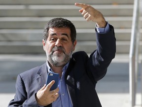 FILE - This is a Monday, Oct. 16, 2017 file photo of  Jordi Sanchez, president of the pro-independence Catalan National Assembly leaves the national court during a break in Madrid, Spain. Catalan separatist Jordi Sanchez's lawyers say the jailed activist is ready to give up his seat in Catalonia's parliament, which would effectively end his bid to become the region's next leader. The law firm defending Sanchez says the offer was made because of difficulties in carrying out his duties as a lawmaker and being blocked by Spain's top court from attending a parliamentary vote to be elected Catalonia's president.