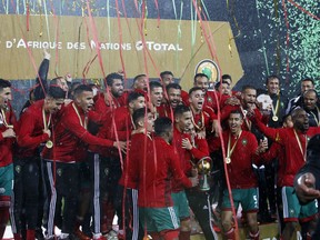 FILE - A Sunday, Feb. 4, 2018 file photo showing Morocco's players celebrating on the podium after defeating Nigeria in the final of the CHAN (African Nations Championship) soccer tournament at the Mohammed V stadium in Casablanca, Morocco. Morocco's stadiums require significant upgrades to get close to matching the infrastructure boasted by the North Americans, whose bid includes 16 NFL venues awash in the luxury seating required by FIFA. But if Morocco is not struck off by a FIFA task force lacking true independence, the vote could be closer than anticipated in part due to new procedures intended to signal a break from the secrecy of the past.