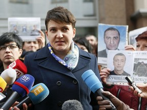 FILE - This is a Tuesday, Feb. 28, 2017 file photo of Ukrainian lawmaker Nadiya Savchenko as she speaks to the media in Kiev, Ukraine. Ukraine's parliament on Tuesday March 20, 2018 approved a bill requiring lawmakers to lock up their guns before entering the chamber. The bill that obliges lawmakers to leave weapons and explosives in lockers follows last week's statement by Prosecutor General Yuriy Lutsenko, who accused lawmaker Nadiya Savchenko, of plotting an attack on parliament with grenades and automatic weapons.