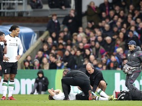 Liverpool's Adam Lallana lays injured on the pitch during the English Premier League soccer match between Crystal Palace and Liverpool, at Selhurst Park, in London, Saturday March 31, 2018.