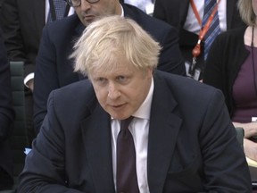 In this image taken from video  Britain's Foreign Secretary Boris Johnson gives evidence to the House of Commons Foreign Affairs Committee in Portcullis House, London Wednesday March 21, 2018. Johnson said Russia carried out a nerve-agent attack on British soil because the U.K. has "time and again called out Russia over its abuses" of human rights and democratic values.