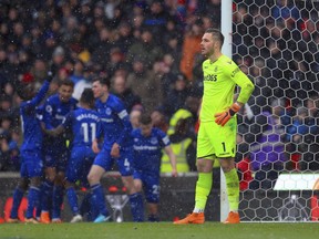 Stoke City goalkeeper Jack Butland gestures as Everton celebrate scoring their side's first goal of the match during the English Premier League soccer match between Stoke City and Everton, at the bet365 Stadium, in Stoke, England, Saturday March 17, 2018.
