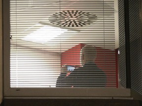 Information Commissioner's Office enforcement officers work inside the offices of Cambridge Analytica in central London after a High Court judge granted a search warrant, Friday March 23, 2018.  The investigation into alleged misuse of personal information continues Friday to determine whether Cambridge Analytica improperly used data from some 50 million Facebook users to target voters with ads and political messages.