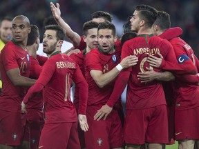 Portugal's Joao Mario, left, Bernardo Silva, Joao Moutinho, middle, celebrate during their soccer friendly game Portugal against Egypt, in the Letzigrund stadium in Zurich, Switzerland, on Friday, March 23, 2018.