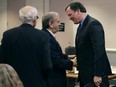 Attorney William Shaheen, centre, who represents lottery winner "Jane Doe," shakes hands with New Hampshire Lottery executive director Charles McIntyre, right, prior to a hearing in the Jane Doe v. NH Lottery Commission case at Hillsborough Superior Court in Nashua, N.H., Tuesday, Feb. 13, 2018.