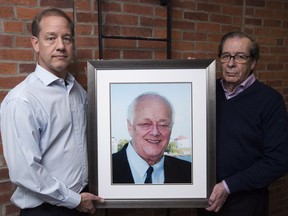 The executors of an Ontario man's will are in a dispute with the Canadian Cancer Society over their request that a major portion of a multimillion-dollar bequest to the charity be directed towards research into pancreatic cancer, one of the deadliest of all malignancies. Jason Clark, left, and Walter Viner pose with a picture of the late Bob Clark in Kingston, Ont., on Tuesday, March 13, 2018.