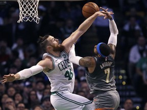 Boston Celtics center Aron Baynes (46) stops a shot by Oklahoma City Thunder forward Carmelo Anthony (7) during the first quarter of an NBA basketball game in Boston, Tuesday, March 20, 2018.