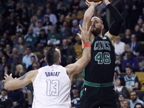 Boston Celtics center Aron Baynes (46) shoots over Washington Wizards center Marcin Gortat (13) during the first quarter of an NBA basketball game in Boston, Wednesday, March 14, 2018.