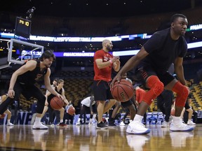 Texas Tech's Keenan Evans, right, dribbles during practice at the NCAA men's college basketball tournament in Boston, Thursday, March 22, 2018. Texas Tech faces Purdue in a regional semifinal on Friday night. At left is Avery Benson.