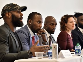 Philadelphia Eagles' Malcolm Jenkins, left, speaks, as former NFL player Anquan Boldin, New England Patriots' Devin McCourty, moderator New York Times Magazine's Emily Bazelon, and New Orleans Saints' Demario Davis listen during a session to discuss criminal justice issues with other current and former NFL football players at Harvard Law School, Friday, March 23, 2018, in Cambridge, Mass.