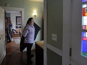 In this March 5, 2018 photo, Wil Darcangelo, left rear, watches as his 22-year-old adopted daughter, Lavender, who is blind and autistic, puts her coat on at their home in Fitchburg, Mass. "Chosen families" have quietly been gaining political recognition in some laws that require paid sick time for millions of private-sector employees to take care of themselves or family members.