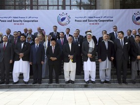 FILE - In this Wednesday, Feb. 28, 2018 file photo, Afghanistan's President Ashraf Ghani, center, poses for a group photo with delegates during the 2nd Kabul Process conference at the Presidential Palace in Kabul. Ghani has put a peace offer on the table, and analysts say the ball is now in the Taliban's court, yet there are no signs the Taliban want to play and some indication they are not interested, at least not yet.