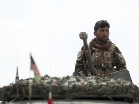 A soldier stands guard near the site of a suicide attack in Kabul, Friday, March 9, 2018. A suicide bomber targeting Afghanistan's minority Hazaras blew himself up at a police checkpoint in western Kabul on Friday, killing nine people and wounding more than a dozen, officials said.