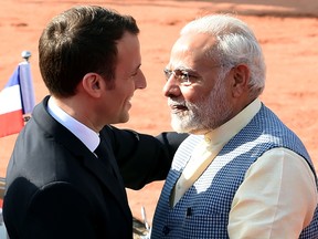 India's Prime Minister Narendra Modi (R) greets France's President Emmanuel Macron upon his arrival for a ceremonial reception at the Indian Presidential Palace in New Delhi on March 10, 2018.