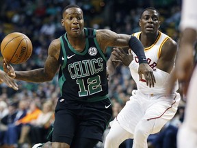 Boston Celtics' Terry Rozier (12) drives past Indiana Pacers' Darren Collison during the first quarter of an NBA basketball game in Boston, Sunday, March 11, 2018.