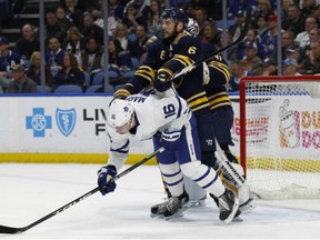 Sabres defenceman Marco Scandella crosschecks Toronto Maple Leafs forward Mitchell Marner during the second period of game, Monday night in Buffalo.