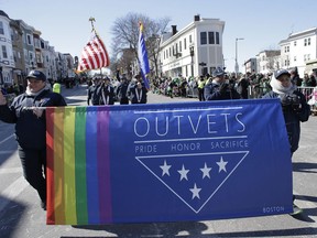 Members of OutVets, a group of gay military veterans, hold a banner and flags as they march in the annual St. Patrick's Day Parade, Sunday, March 18, 2018, in Boston. Boston's popular St. Patrick's Day parade is all about veterans, but not all who've served in uniform were allowed to march in the parade. Veterans for Peace, the anti-war group, wasn't allowed to walk in Sunday's parade.