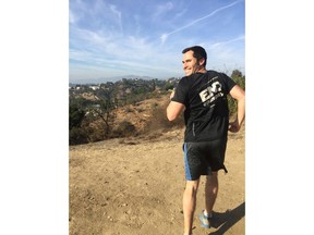 In this Nov. 26, 2017, photo provided by Rose Zitomersky, movie production lawyer Loren Zitomersky practices running backward in the San Rafael Hills of northeast Los Angeles. Zitomersky, 33, has embarked on a singular, if odd, quest: At the 2018 Boston Marathon, he'll attempt to break the world record for running the distance backward. Zitomersky is trying to raise money and awareness for a cure for epilepsy.