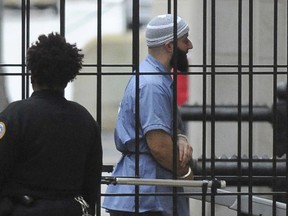 FILE - In this Feb. 3, 2016 file photo, Adnan Syed enters Courthouse East in Baltimore prior to a hearing.    A Maryland appeals court has upheld a ruling, Thursday, March 29, 2018,  granting a new trial to Syed, whose conviction in the murder of his high school sweetheart became the subject of the popular podcast "Serial." Syed was convicted in 2000 of killing Hae Min Lee and burying her body in a shallow grave in a Baltimore park. A three-judge panel on Thursday upheld a lower court ruling granting him new trial.