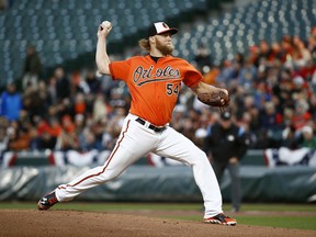 Baltimore Orioles starting pitcher Andrew Cashner throws to the Minnesota Twins in the first inning of a baseball game, Saturday, March 31, 2018, in Baltimore.