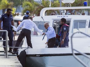 The Maldives longtime former dictator Maumoon Abdul Gayoom, center, arrives for a hearing at a criminal court in Male, Maldives, Wednesday, March 21, 2018. Authorities charged Gayoom and top judges and police officials with terrorism Tuesday as the government deals with political turmoil that prompted a weeks-long state of emergency.