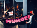 Toronto chef Michael Hunter butchers a deer leg as animal-rights protesters watch on horrified from outside the front window of Antler Kitchen and Bar on Friday, March 23.