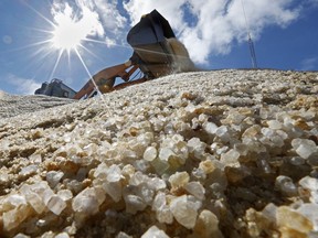 Road salt is mixed by a front-end loader prior to be loaded onto public works trucks, Monday, March 12, 2018, in Freeport, Maine. Much of the Northeast is bracing for blizzard conditions, a foot or more of snow and high winds as another major nor'easter bears down on the region.